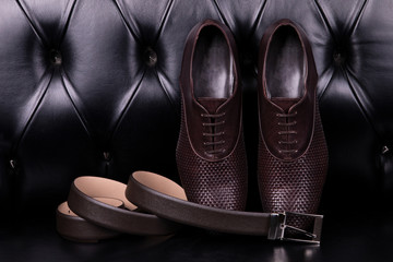 Elegant shoes and a belt for trousers. A pair of classic men's shoes and belt.