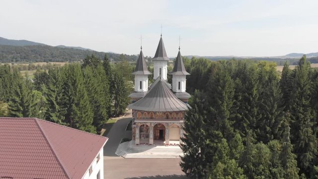 Monastery of St John Jacob Chozebite, Neamt, Romania. Christian Orthodox Church. Aerial Filming. Flying towards