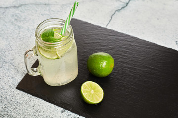 Fototapeta premium Lemonade with lemons on a slate board..Summer drink. Lemon fresh.