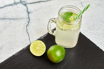 Lemonade with lemons on a slate board..Summer drink. Lemon fresh.