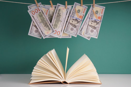 money and open book with blank pages