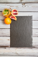 Fresh orange on a wooden background. Juice in a jar. Summer drink. Orange on a wooden background..View from above.