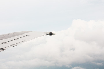 Aircraft Wing on the beautiful heaven and destination of journey on blue sky and cloud in sunlight