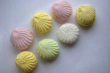 Air marshmallows in pastel shades. A gentle marshmallows. Marshmallows that you want to eat. A gentle zephyr on a white background. Marshmallows in a light key