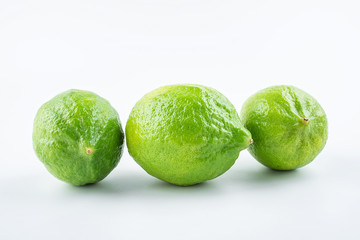 Fresh green lemon on white background