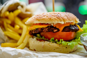 burger and french fries on wooden table. fast food