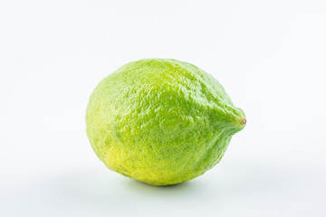Fresh green lemon on white background