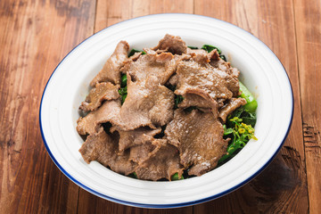 Boiled beef tongue with vegetables is served on a plate in a restaurant