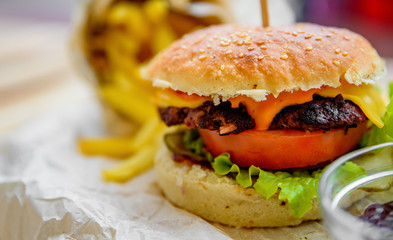 burger and french fries on wooden table. fast food