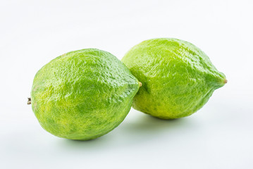 Fresh green lemon on white background