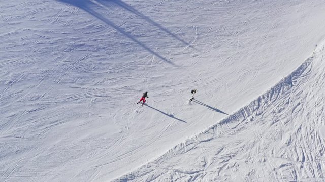 Aerial Shot of Skiers Coming Down the Slope.
Overview of Skiers Going Downhill from Snowy Slope.