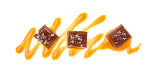 Delicious salted caramel with sauce on white background, top view