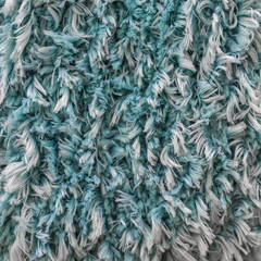 Turquoise white shaggy faux long fur close up