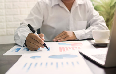 business man or banker checking profit finance graph on table