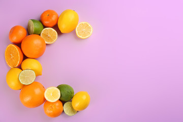 Fototapeta na wymiar Letter C made with citrus fruits on lilac background as vitamin representation, flat lay. Space for text