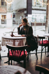 Young woman reading book in cafe