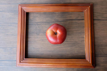 red apple on wooden table