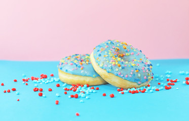 Donuts with sprinkles on colorful background.
