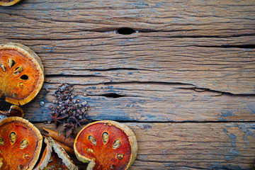 Cinnamon sticks ,anise stars and dried quince on old wooden plates.