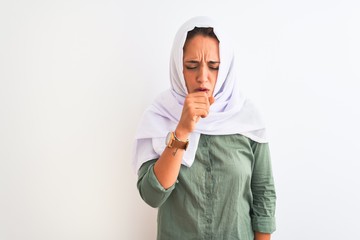 Young beautiful Arab woman wearing traditional Muslim hijab over isolated background feeling unwell and coughing as symptom for cold or bronchitis. Healthcare concept.