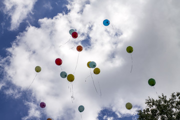 inflatable balloons in the sky released into the sky at graduation in school kindergarten. Multicolored inflatable balloons with helium flying in the sky