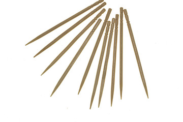 wooden toothpicks scattered on a white background