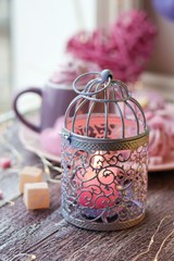  Decorative lantern with candles, a cup of coffee, dessert, romantic decor on a window background, homeliness, Valentine's Day