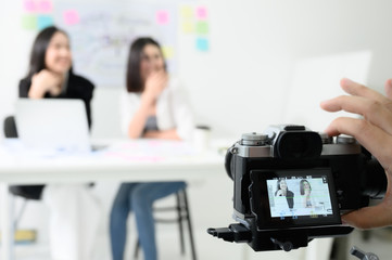 Behind the scene concept. Videographer working by camera recorder digital footage in workplace room
