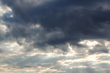 The rays of sunlight making their way through the clouds