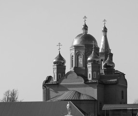 Domes of the Christian church against the sky in gray