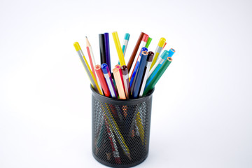Jar full of different colored pencils and crayons on a white background