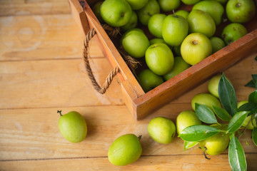 Indian jujubes in basket on table.Chinese date.Fresh jujubes. Fresh and delicious Indian jujube fruit with cut pulp. Jujube seed with wood background.