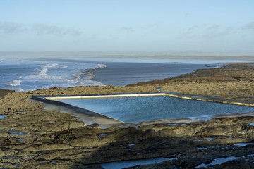 Rockpools at Westward Ho looking across Bideford Bay