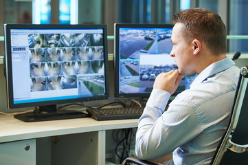 Security worker during monitoring. Video surveillance system. - obrazy, fototapety, plakaty
