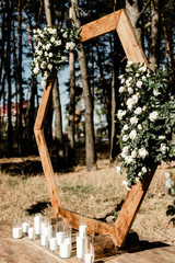Blooming decoration of wedding arch with roses, hydrangea and eucalyptus. Wedding wood decoration....