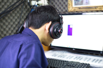 A man sitting and listening to music in the learning room after mixing the singing song