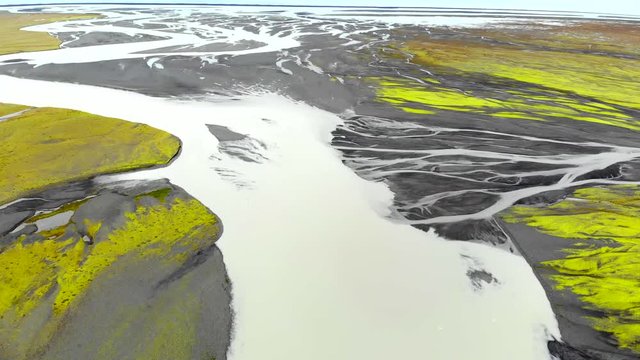 Aerial view of a glacier river delta flows into the Atlantic Ocean, Iceland. Drone shot.
