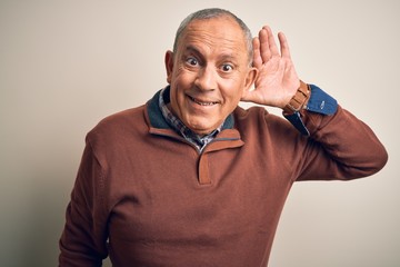 Senior handsome man  wearing elegant sweater standing over isolated white background smiling with...