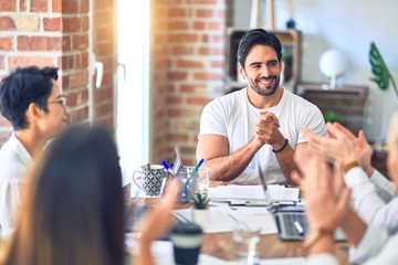 Group of business workers smiling happy and confident. Working together with smile on face applauding one of them at the office