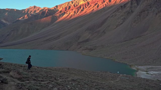 A person walking towards chandratal lake , spiti valley
