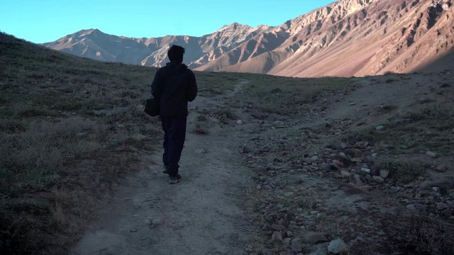 Silhouette of a man walking in the mountains at chandratal lake , spiti valley