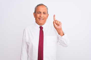 Senior grey-haired businessman wearing elegant tie over isolated white background showing and pointing up with finger number one while smiling confident and happy.
