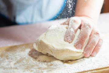Knead the dough on a wooden board