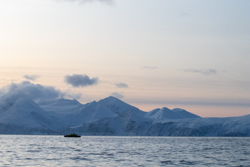 rib boat in the Arctic polar sea for excursions and whale and cetacean observation. Whale watching in the arctic in northern europe. Zodiac inflatable boat on the North Sea