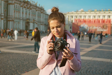 young woman trying to figure out how a camera works