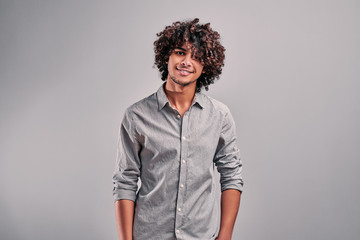 Fototapeta na wymiar Egyptian stylish student in gray shirt on isolated gray background