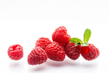 Ripe raspberries on a white background. A sprig of fresh mint. Berries. Garden raspberries. White background. Red berries. Isolated.