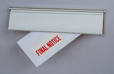 A letter in a mail slot - Final Notice