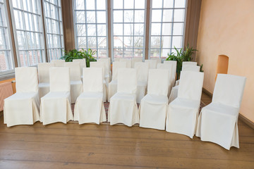 City Cesis, Latvia. White wedding chairs stand in rows.