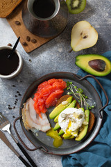 Valentine's day breakfast. Boiled egg sandwich with avocado, coffee, salmon and smoked salmon on a stone concrete tabletop. Top view flat lay background.